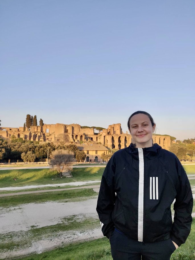 An image of Tilda standing in front of the forum in Rome.
